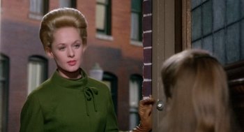 Movie still from “Marnie” (1964), directed by Alfred Hitchcock – An older woman in a green coat looking at a woman in a green dress; Medium shot, Over the shoulder angle