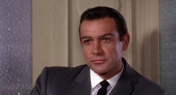 Movie still from “Marnie” (1964), directed by Alfred Hitchcock – A person wearing a suit and tie; Close Up shot, Over the shoulder angle