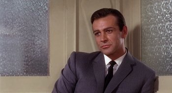 Movie still from “Marnie” (1964), directed by Alfred Hitchcock – A person wearing a suit and tie; Close Up shot, Over the shoulder angle