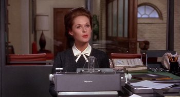 Movie still from “Marnie” (1964), directed by Alfred Hitchcock – A woman sitting in front of an old fashioned typewriter; Medium shot, Low angle