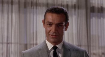 Movie still from “Marnie” (1964), directed by Alfred Hitchcock – A person wearing a suit and tie; Close Up shot, Low angle
