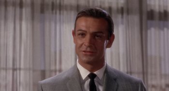 Movie still from “Marnie” (1964), directed by Alfred Hitchcock – A person wearing a suit and tie; Close Up shot, Low angle