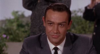 Movie still from “Marnie” (1964), directed by Alfred Hitchcock – A person wearing a suit and tie; Close Up shot, High angle