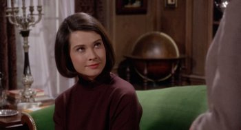 Movie still from “Marnie” (1964), directed by Alfred Hitchcock – A woman sitting on top of a green couch in a room; Close Up shot, High angle