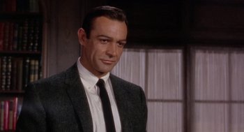 Movie still from “Marnie” (1964), directed by Alfred Hitchcock – A person wearing a suit and tie; Close Up shot, Over the shoulder angle