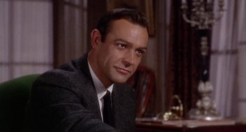 Movie still from “Marnie” (1964), directed by Alfred Hitchcock – A person wearing a suit and tie; Close Up shot, Over the shoulder angle