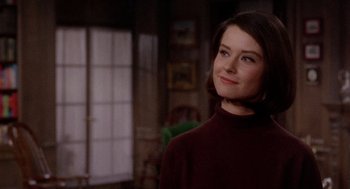 Movie still from “Marnie” (1964), directed by Alfred Hitchcock – A woman in a brown sweater standing next to a window; Close Up shot, Over the shoulder angle