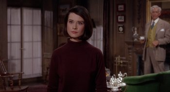 Movie still from “Marnie” (1964), directed by Alfred Hitchcock – A woman standing in front of a table with tea cups on it; Medium shot, Over the shoulder angle