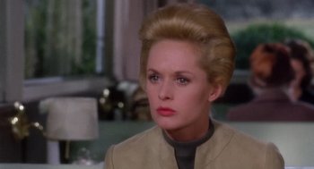 Movie still from “Marnie” (1964), directed by Alfred Hitchcock – A woman that is wearing a jacket; Close Up shot, Over the shoulder angle