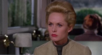 Movie still from “Marnie” (1964), directed by Alfred Hitchcock – A woman that is wearing a suit; Close Up shot, Over the shoulder angle