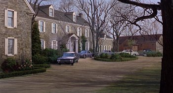 Movie still from “Marnie” (1964), directed by Alfred Hitchcock – A group of cars parked in front of a large house; Extreme Wide shot, High angle