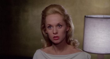 Movie still from “Marnie” (1964), directed by Alfred Hitchcock – A woman with blonde hair wearing a white top; Close Up shot, High angle