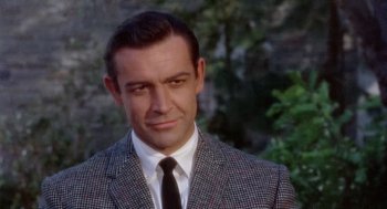 Movie still from “Marnie” (1964), directed by Alfred Hitchcock – A person wearing a suit and tie; Close Up shot, High angle