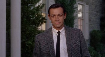 Movie still from “Marnie” (1964), directed by Alfred Hitchcock – A person wearing a suit and tie; Close Up shot, Low angle