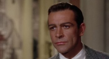 Movie still from “Marnie” (1964), directed by Alfred Hitchcock – A person wearing a suit and tie; Close Up shot, Over the shoulder angle