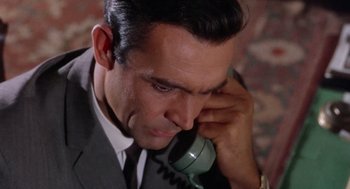 Movie still from “Marnie” (1964), directed by Alfred Hitchcock – A person talking on a phone; Close Up shot, High angle