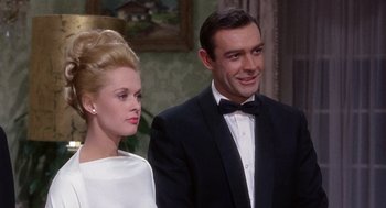 Movie still from “Marnie” (1964), directed by Alfred Hitchcock – A man and a woman standing next to each other in a room; Medium shot, Low angle