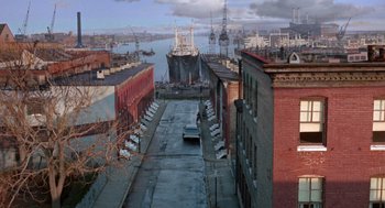 Movie still from “Marnie” (1964), directed by Alfred Hitchcock – A view of a city with a boat in the water; Extreme Wide shot, High angle