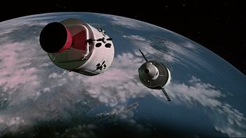 Movie still from “Marooned” (1969), directed by John Sturges – An image of a space ship in the sky above the earth; Extreme Wide shot, Overhead angle