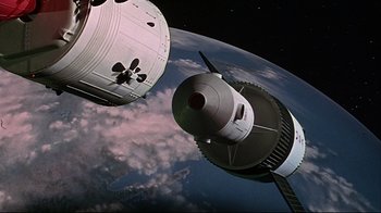 Movie still from “Marooned” (1969), directed by John Sturges – An image of a space station in the sky; Extreme Wide shot, Overhead angle