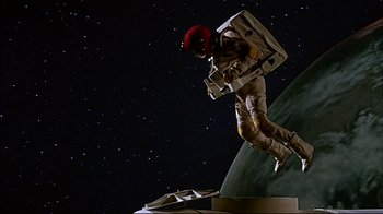Movie still from “Marooned” (1969), directed by John Sturges – An image of a man in a spacesuit on a planet; Wide shot, Overhead angle