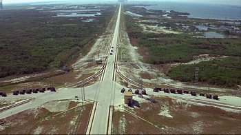 Movie still from “Marooned” (1969), directed by John Sturges – An aerial view of a train track and a road; Extreme Wide shot, High angle