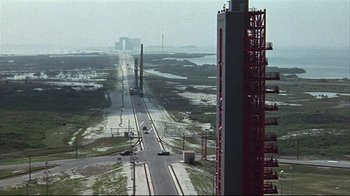 Movie still from “Marooned” (1969), directed by John Sturges – An aerial view of an industrial area with a road and buildings; Extreme Wide shot, High angle