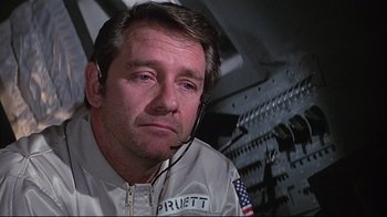 Movie still from “Marooned” (1969), directed by John Sturges – An older man wearing a white jacket and headphones; Close Up shot, Low angle