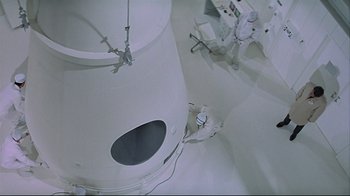 Movie still from “Marooned” (1969), directed by John Sturges – An overhead view of a person in a room; Extreme Wide shot, High angle