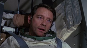 Movie still from “Marooned” (1969), directed by John Sturges – A person wearing a space suit; Close Up shot, High angle