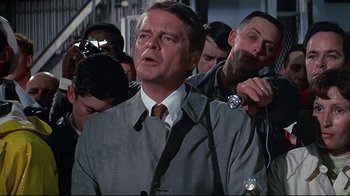 Movie still from “Marooned” (1969), directed by John Sturges – A group of men standing next to each other in a room; Medium shot, Low angle