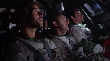 Movie still from “Marooned” (1969), directed by John Sturges – Three men in space suits in the cockpit of an airplane; Medium shot, Low angle