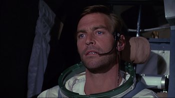 Movie still from “Marooned” (1969), directed by John Sturges – A person wearing a space suit; Close Up shot, Low angle