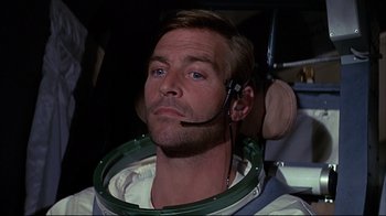 Movie still from “Marooned” (1969), directed by John Sturges – A person wearing a space helmet; Close Up shot, Low angle