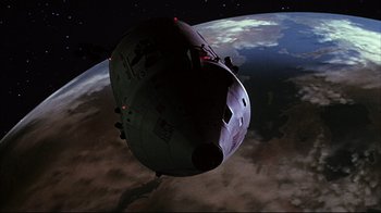 Movie still from “Marooned” (1969), directed by John Sturges – An image of a space ship in the sky above the earth; Extreme Wide shot, Overhead angle