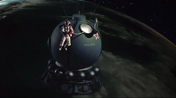 Movie still from “Marooned” (1969), directed by John Sturges – An inflatable figure of a man on top of an object; Wide shot, Overhead angle