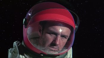 Movie still from “Marooned” (1969), directed by John Sturges – A person wearing a space helmet; Close Up shot, Low angle
