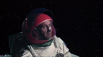 Movie still from “Marooned” (1969), directed by John Sturges – A man in a spacesuit is looking at the stars; Close Up shot, Low angle