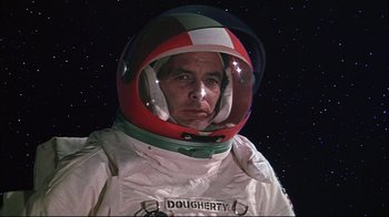 Movie still from “Marooned” (1969), directed by John Sturges – A man in a spacesuit with a helmet on; Close Up shot, Low angle