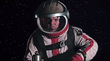 Movie still from “Marooned” (1969), directed by John Sturges – A man wearing a space suit and helmet; Medium shot, Low angle