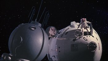 Movie still from “Marooned” (1969), directed by John Sturges – An image of a space station in the night sky; Extreme Wide shot, Low angle