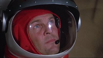 Movie still from “Marooned” (1969), directed by John Sturges – A person wearing a space helmet; Close Up shot, Low angle