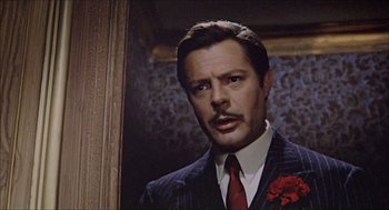 Movie still from “Marriage Italian Style” (1964), directed by Vittorio De Sica – A person wearing a suit and tie; Close Up shot, Over the shoulder angle