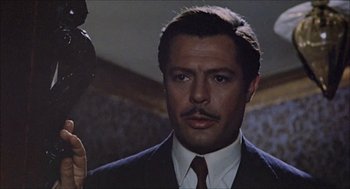 Movie still from “Marriage Italian Style” (1964), directed by Vittorio De Sica – A person wearing a suit and tie; Close Up shot, Low angle