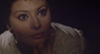 Movie still from “Marriage Italian Style” (1964), directed by Vittorio De Sica – A woman's face in a dark room; Close Up shot, Over the shoulder angle