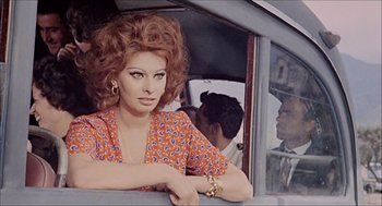 Movie still from “Marriage Italian Style” (1964), directed by Vittorio De Sica – A woman in a red and white dress leaning on a window; Medium shot, Over the shoulder angle