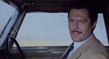 Movie still from “Marriage Italian Style” (1964), directed by Vittorio De Sica – A person wearing a suit and tie; Close Up shot, Low angle