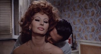 Movie still from “Marriage Italian Style” (1964), directed by Vittorio De Sica – A man and a woman are kissing in a room; Close Up shot, Low angle