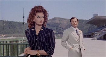 Movie still from “Marriage Italian Style” (1964), directed by Vittorio De Sica – A man and a woman standing next to each other; Medium shot, Low angle