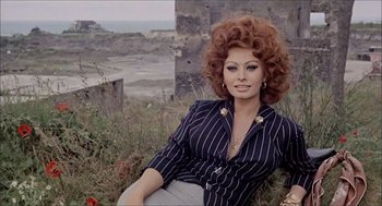 Movie still from “Marriage Italian Style” (1964), directed by Vittorio De Sica – A woman sitting on the ground in front of a building; Medium shot, High angle